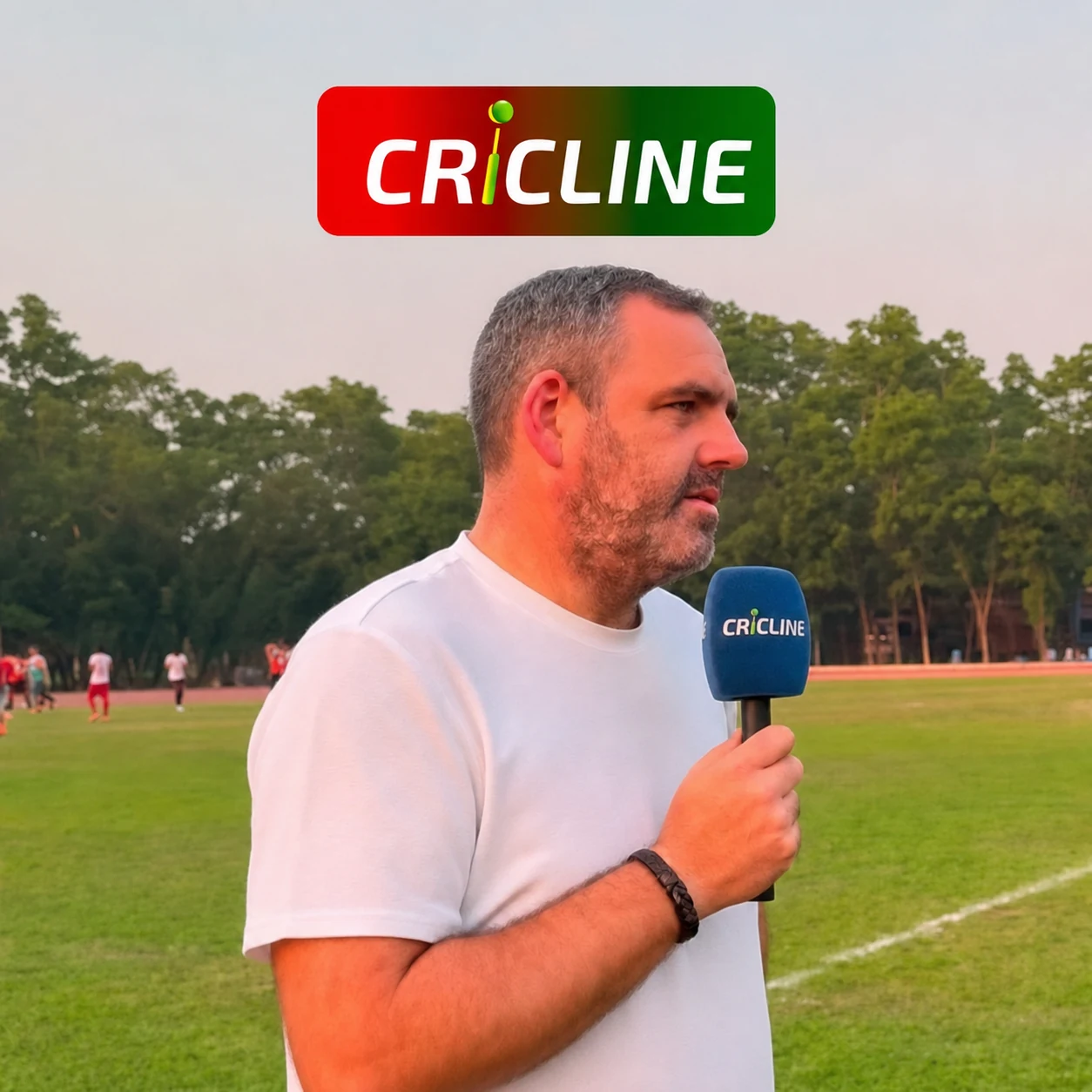 Ray Power being interviewed beside a football pitch under the Cricline logo